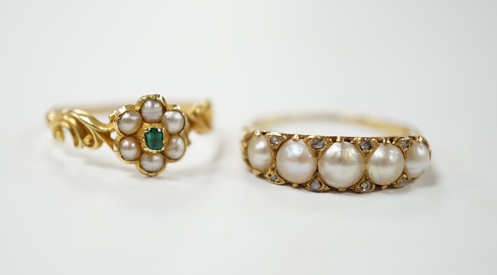 A yellow metal and graduated split pearl set half hoop ring with diamond chip spacers, size Q and a similar emerald and seed pearl flower head cluster ring, gross weight 5.7 grams. Condition - fair